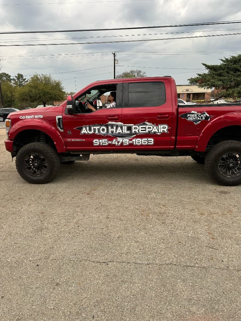 C & D Dent Guys red Ford Super Duty — driver side with Auto Hail Repair branding